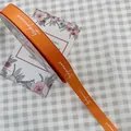 Orange grosgrain ribbon with white Serendipity text for gift wrapping - Serendipity / 1.5cm x 50 Yards / Honey Orange