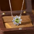 Detailed close-up of S925 silver necklace with peridot flower pendant in wooden box - Peridot (N537)