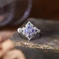 Close-up of vintage S925 silver ring with purple tanzanite gemstones on stone background - Natural Tanzanite (R565)