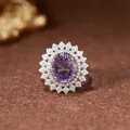 Close-up of a sunburst sterling silver ring with a large oval purple amethyst gemstone - Natural Amethyst