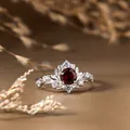 Detailed macro view of vintage leaf design S925 silver ring featuring a red garnet center - Silver / Natural Garnet