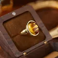 Close-up detail of a vintage golden ring featuring an oval tiger eye stone in a wooden gift box - Oval Cabochon Open Ring (R554) / Natural Citrine (Gold)