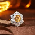 Close-up of S925 silver ring featuring an oval citrine in a floral halo setting - Natural Citrine Ring / Yellow