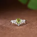 Detailed close-up of a leaf-pattern silver ring with heart-shaped peridot gemstone - Natural Peridot Ring