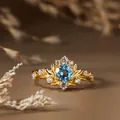 Gros plan sur une bague vintage branche dorée ornée d'une topaze bleue centrale éclatante - Or / Topaze Naturelle