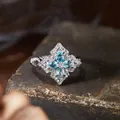 Detailed close-up of a vintage s925 silver ring featuring blue gemstones in floral cross design - Natural Apatite (R565)