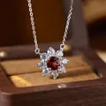 Close-up detail of a S925 sterling silver flower pendant featuring a red garnet center - Garnet (N537)