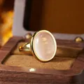 Detailed view of an elegant rose quartz ring with smooth oval stone in a wooden gift box - Oval Cabochon Open Ring (R554) / Natural Rose Quartz (Gold)