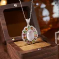 Detail view of a multi-gemstone floral pendant in silver with a large rose quartz center. - Natural Rose Quartz Necklace