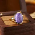 Macro view of a natural oval purple stone ring in an elegant gold-tone setting - Oval Cabochon Open Ring (R554) / Natural Charoite (Gold)