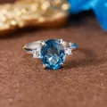 Close-up view of an S925 silver ring featuring a large oval Swiss blue topaz gemstone - Natural Topaz Silver