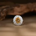 Close-up of s925 silver ring with oval yellow citrine and brilliant halo accents - Natural Citrine Ring