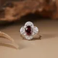 Detailed macro shot of a vintage s925 silver floral ring set with a natural red garnet - Adjustable / Natural Garnet Ring