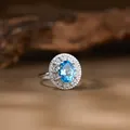 Macro view of a natural blue topaz oval ring set in detailed S925 silver filigree. - Natural Topaz Ring