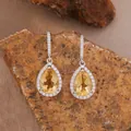 Macro detail view of pear-cut yellow citrine drop earrings on natural stone background - Natural Citrine Stud Earrings