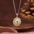 Detailed macro shot of a sun flower pendant necklace featuring a natural blue topaz - Sunflower Style / Natural Apatite Necklace