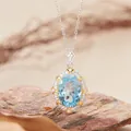 Macro detail of oval blue topaz pendant with sparkling halo on natural rock - Natural Topaz Necklace