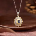 Close-up detail of vintage sunburst pendant with oval blue sapphire stone - Sunflower Style / Natural Sapphire Necklace