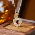 Close-up of gold-plated sterling silver necklace with oval garnet and cubic zirconia - Natural Garnet Gold