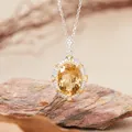 Detailed close-up of elegant oval citrine pendant necklace with sparkling stone accents - Natural Citrine Necklace