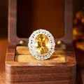 Macro detail of a natural yellow citrine ring with halo setting in wooden jewelry box - Ring / Natural Citrine + Silver