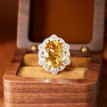 Detailed view of an oval millennium cut yellow citrine ring in a S925 silver halo setting - Ring / Natural Citrine Ring