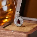 Macro detail of a vintage S925 silver necklace with an oval red garnet gemstone - Natural Garnet Silver