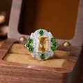 Macro view of vintage palace style S925 silver ring with yellow citrine and green gems - Natural Diopside and Citrine