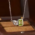Close-up of S925 silver necklace with emerald-cut green and pear-cut clear gemstones - Natural Peridot & White Crystal