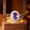 Close-up of a large oval amethyst ring with halo in a wooden gift box - Ring / Natural Amethyst + Silver