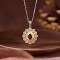 Macro view of vintage floral garnet pendant necklace with gold and silver accents - Sunflower Style / Natural Garnet Necklace