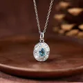 Close-up of a blue gemstone pendant on a S925 silver necklace with sparkling halo - Natural Topaz Necklace (White Gold Color)