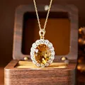 Close-up of a large oval yellow citrine pendant with millennium cut in a gold-plated silver setting. - Natural Citrine Necklace Gold