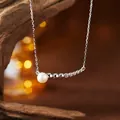 Detailaufnahme der S925 Silberlächeln-Halskette mit Naturperle und Zirkonia-Akzenten - Naturperlen Halskette / Silber