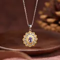 Macro view of floral tanzanite pendant necklace with purple gemstone and gold accents - Sunflower Style / Natural Tanzanite Necklace