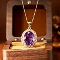 Detailed macro view of an elegant millennium cut oval amethyst pendant with gold filigree - Natural Amethyst Necklace Gold