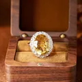 Detailed close-up of a large oval citrine ring set in a luxury wooden display box. - Oval Cut Ring (R609) / Natural Citrine Ring