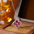 Macro detail of a silver necklace with a ruby-set four-leaf clover pendant - Natural Ruby Necklace / 41-50cm