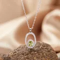 Detailed macro shot of an elegant oval peridot pendant necklace with S925 silver chain - Necklace / Peridot