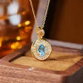 Macro detail of oval blue topaz pendant with gold-plated silver chain and pavé stones - Natural Topaz Gold