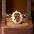 Macro view of a large millennium cut citrine gemstone set in silver halo ring - Natural Citrine Ring