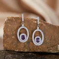 Detailed view of S925 silver oval drop earrings featuring a natural purple amethyst stone. - Stud Earrings / Amethyst