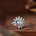 Elegant daisy flower S925 silver ring featuring a sparkling oval natural blue topaz stone - Ring / Natural Topaz