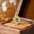 Detailed macro view of an oval green gemstone pendant with micro-pave crystals - Natural Olivine Gold