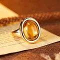 Macro detail of an oval yellow crystal ring with a 24K gold-plated setting. - Citrine (R611) / Natural Citrine Ring