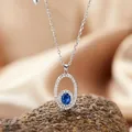 Elegant S925 sterling silver necklace with oval blue sapphire pendant and sparkling halo - Necklace / Sapphire