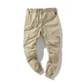 Detail view of khaki cotton cargo joggers with side pockets and drawstring waist - M / Bottoms / Khaki