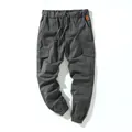 Detailed view of grey cotton cargo pants with drawstring waist and multi-pockets - Iron Gray