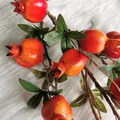 Vibrant artificial pomegranate branch with red fruits and green leaves for decor - Pomegranate Branch