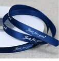 Detail shot of navy blue polyester ribbon featuring white Just for you cursive print - 1cm * 90 Yards / Navy Blue
